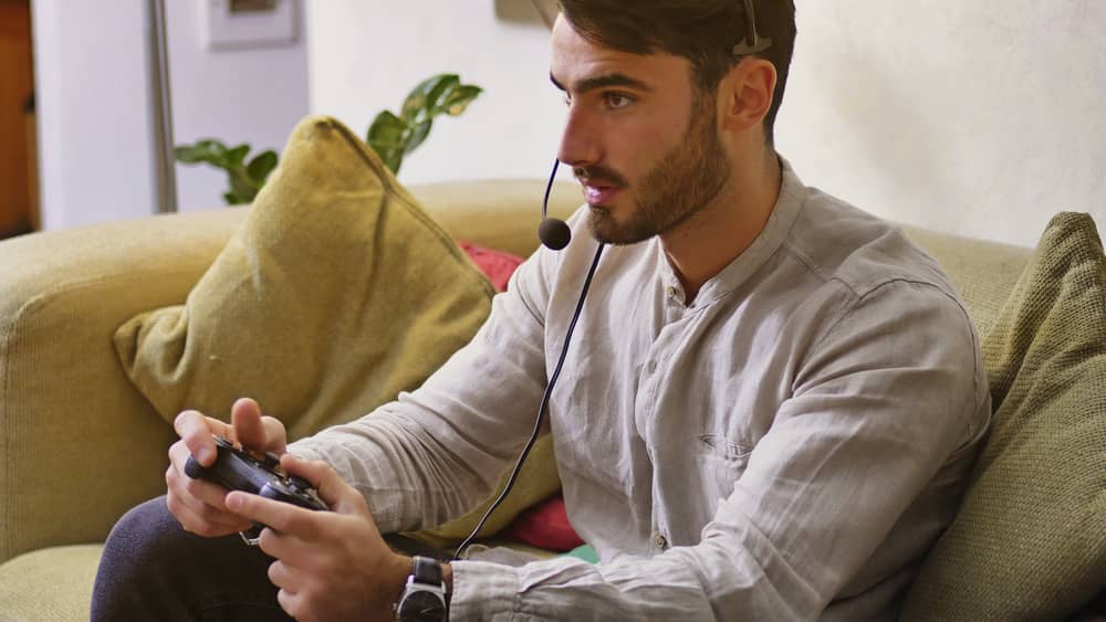 Man playing video games with ultra-low latency headset