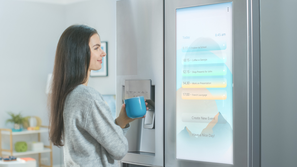 Woman using smart home refrigerator